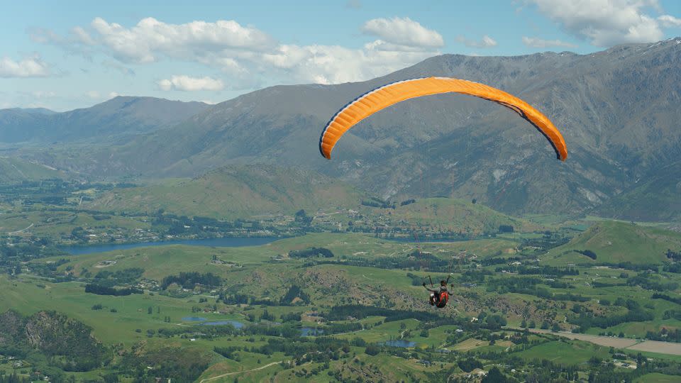 A paraglider takes to the the sky in New Zealand, where outdoor activities and Christmas meet. - damianalmua/Adobe Stock