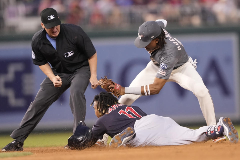 Cleveland Guardians' Jose Ramirez (11) is tagged out at second base by Washington Nationals shortstop CJ Abrams, right, during the third inning of a baseball game in Washington, Friday, April 14, 2023. (AP Photo/Manuel Balce Ceneta)