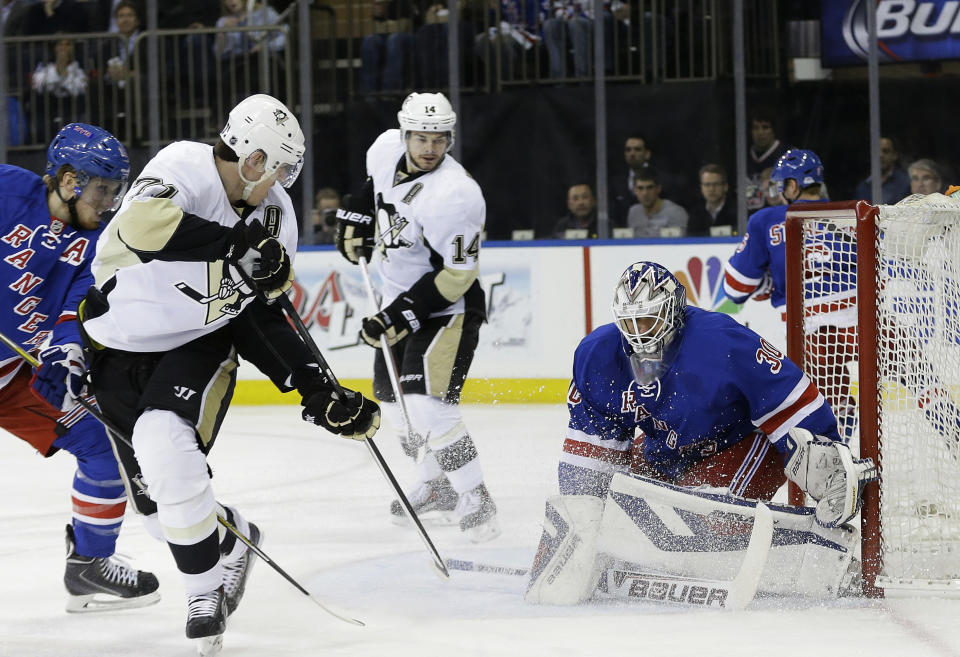 Pittsburgh Penguins' Evgeni Malkin, second from left, of Russia, shoots the puck past New York Rangers' Henrik Lundqvist (30), of Sweden, during the first period of their second-round NHL Stanley Cup hockey playoff series Wednesday, May 7, 2014, in New York. (AP Photo/Frank Franklin II)