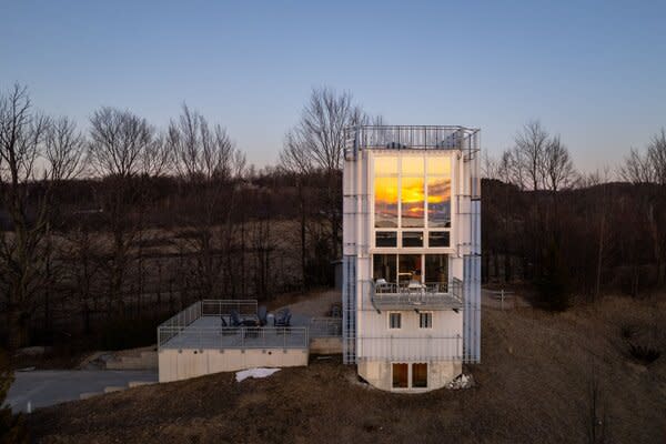 Perched on a one-acre lot surrounded by rolling hills, the home frames striking views of Lake Michigan, the Manitou Islands, and the Crib Lighthouse.