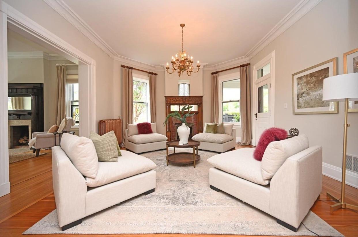 The living room features one of six fireplaces in the house.