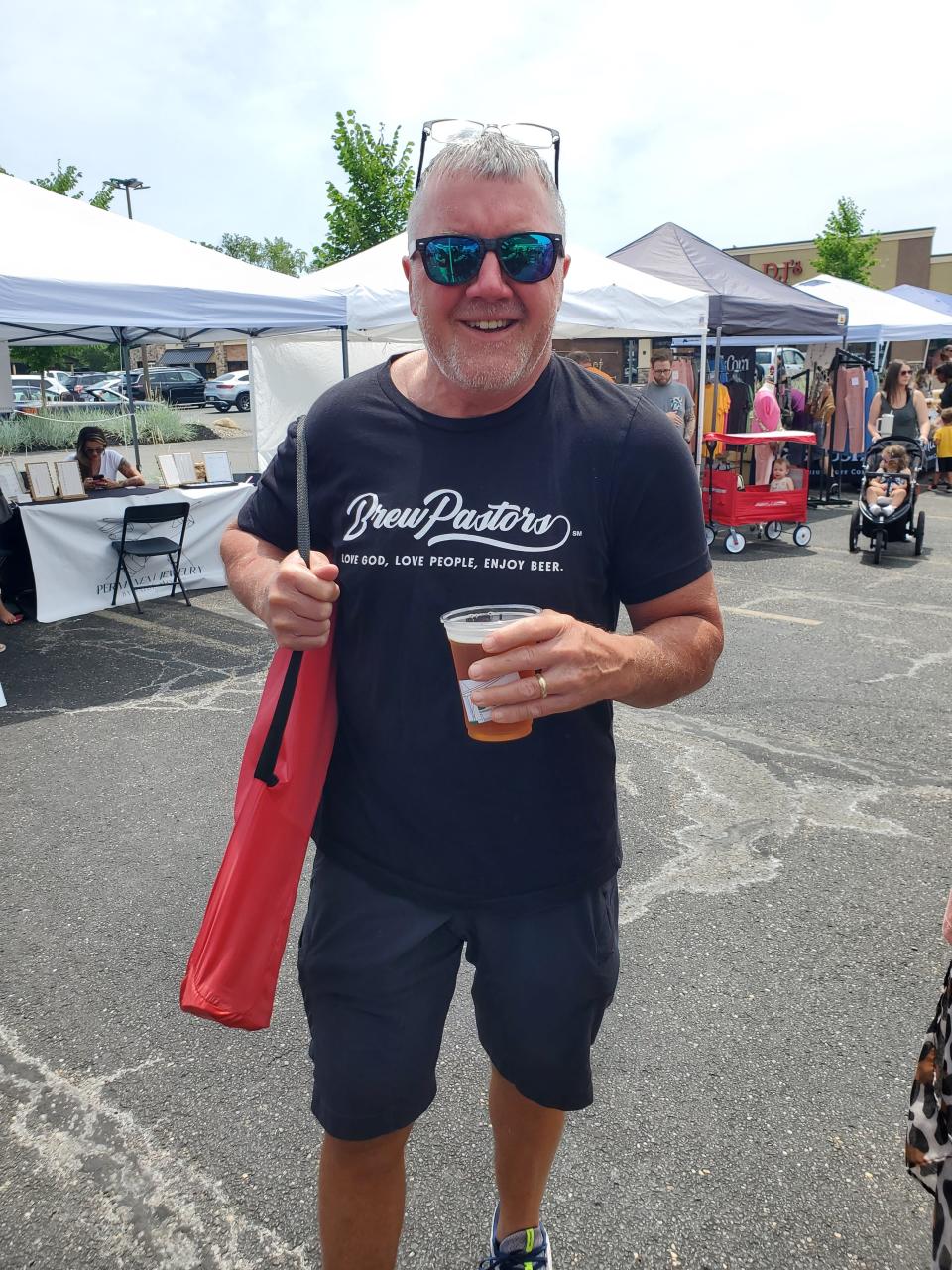 Brew Pastors' Roger Schuler is seen at the 720 Market at Oakwood Square in Plain Township. The group has a tent at the event.