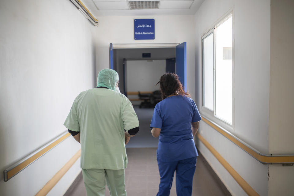 In this photo taken on Wednesday, April 15, 2020, healthcare workers walk together near one of the COVID-19 intensive care units (ICU) of the Moulay Abdellah hospital in Sale, Morocco. Coronavirus has upended life for Morocco's medical workers. They enjoy better medical facilities than in much of Africa but are often short of the equipment available in European hospitals, which also found themselves overwhelmed. (AP Photo/Mosa'ab Elshamy)