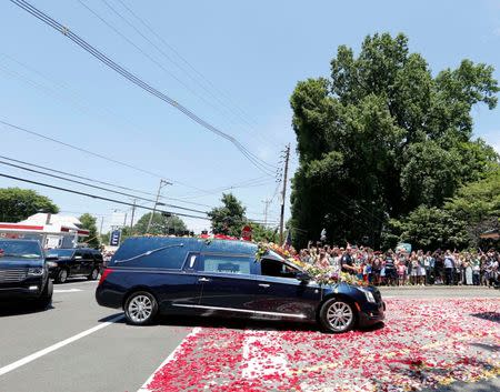 Jun 10, 2016; Louisville, KY, USA; The hearse draped with flowers carrying Muhammad Ali arrives at Cave Hill Cemetery. Mandatory Credit: Mark Zerof-USA TODAY Sports