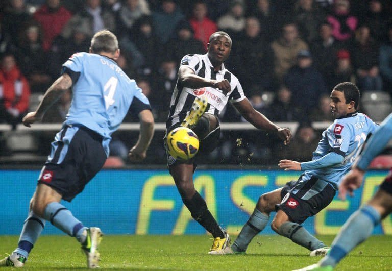 Newcastle's Shola Ameobi (C) scores during their Premier League match against Queens Park Rangers on December 22, 2012. Newcastle ended a miserable run of six defeats from their last seven league games as Ameobi clinched a 1-0 victory against QPR