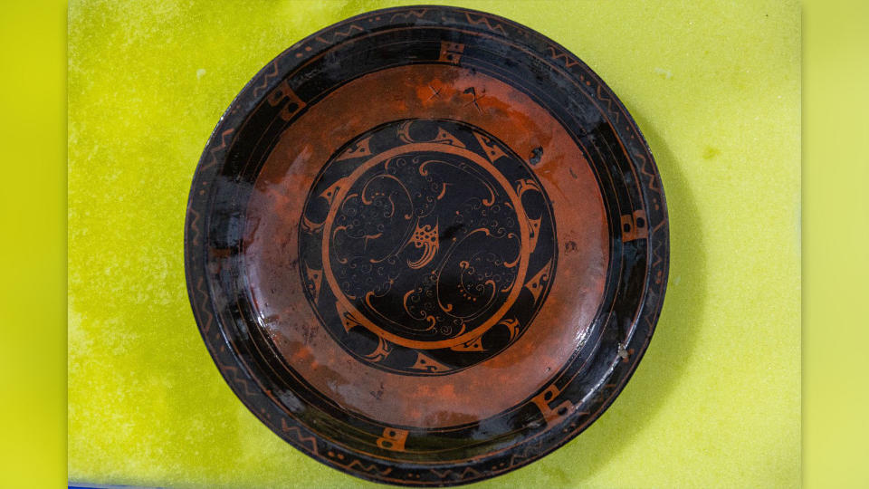 The hundreds of artifacts buried in the tomb include ornate objects of pottery, copper, bronze, wood, bamboo, and lacquerware, such as this plate.