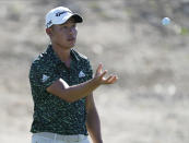 Collin Morikawa, of the United States, catches a ball at the 6th green during the final round of the Hero World Challenge PGA Tour at the Albany Golf Club, in New Providence, Bahamas, Sunday, Dec. 5, 2021.(AP Photo/Fernando Llano)