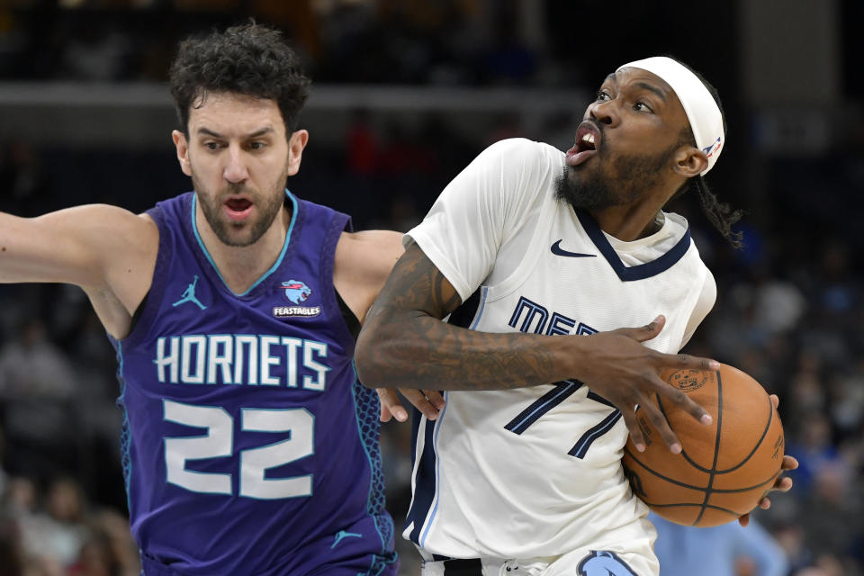 Memphis Grizzlies guard DeJon Jarreau (77) is defended by Charlotte Hornets guard Vasilije Micic (22) during the first half of an NBA basketball game Wednesday, March 13, 2024, in Memphis, Tenn. (AP Photo/Brandon Dill)