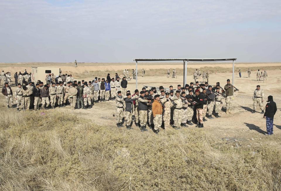 In this Wednesday, Feb. 1, 2017 photo, Nineveh police forces train with Spanish coalition members at Basmaya base 40 kilometers southeast of Baghdad, Iraq. The U.S.-led coalition is planning for the day Iraq will be free of the Islamic State group, ramping up the training of a future Mosul police force -- even as the battle for the city is temporarily on hold. The security forces are expected to move into villages of Ninevah province around Mosul and into parts of the city recently retaken from IS. The Iraqi military declared Mosul’s eastern half “fully liberated” in January and is now preparing to battle for the city’s western sector. (AP Photo/Karim Kadim)