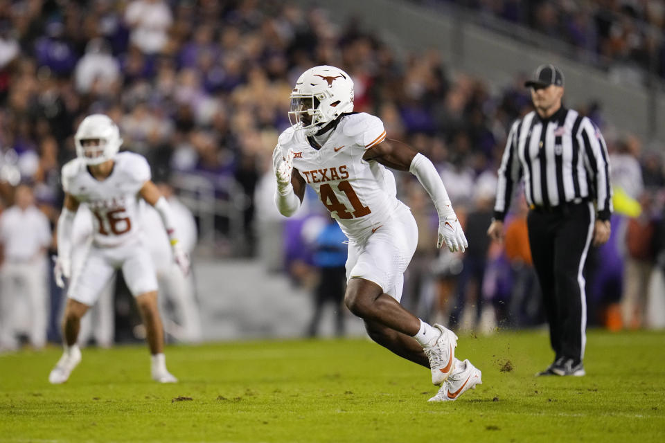 FILE - Texas linebacker Jaylan Ford rushes in during the first half of an NCAA college football game between TCU and Texas, Nov. 11, 2023, in Fort Worth, Texas. Texas is back — fourteen years after last playing for a national championship, Texas (12-1) is in the College Football Playoff as Big 12 champion. (AP Photo/Julio Cortez, File)
