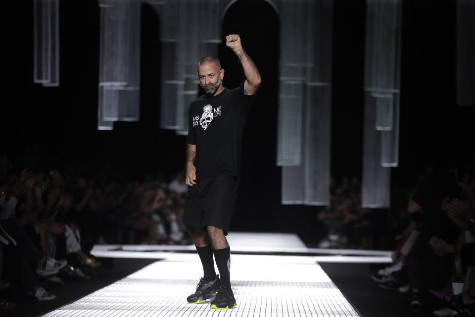 Designer Marcelo Burlon accepts applause at the end of his men's Spring-Summer 2020 collection, unveiled during the fashion week, in Milan, Italy, Saturday, June 15, 2019. (AP Photo/Luca Bruno)