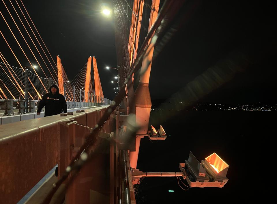 Lighting fixtures are mounted off the side of the Gov. Mario Cuomo Bridge to illuminate the cables of the bridge Oct. 31, 2023. The bridge was lit up by red lights for Halloween.