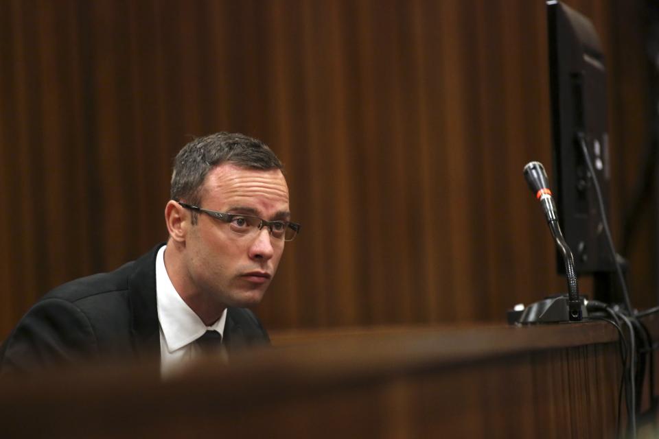 Olympic and Paralympic track star Oscar Pistorius sits in the dock during his trial for the murder of his girlfriend Reeva Steenkamp, at the North Gauteng High Court in Pretoria, March 17, 2014. Pistorius is on trial for murdering his girlfriend Reeva Steenkamp at his suburban Pretoria home on Valentine's Day last year. He says he mistook her for an intruder. REUTERS/Siphiwe Sibeko (SOUTH AFRICA - Tags: CRIME LAW SPORT ATHLETICS)