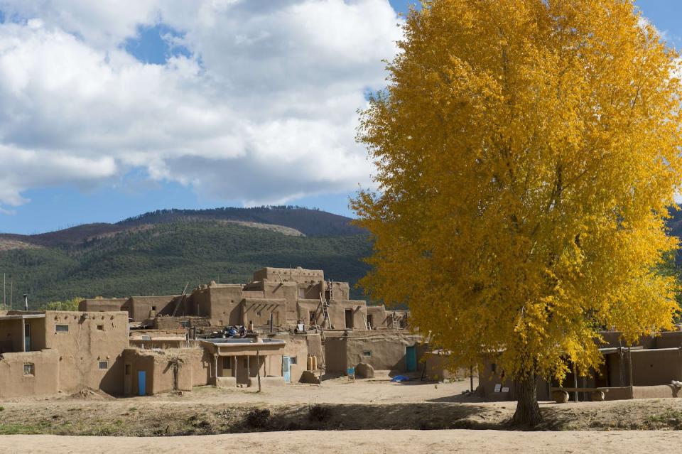 Taos Pueblo in Taos, New Mexico, is a living Native American community that has been designated both a World Heritage Site by UNESCO and a National Historic Landmark. <a href="https://www.gettyimages.com/detail/news-photo/trees-with-fall-colors-at-the-taos-pueblo-which-is-the-only-news-photo/909633522" rel="nofollow noopener" target="_blank" data-ylk="slk:Wolfgang Kaehler/LightRocket via Getty Images;elm:context_link;itc:0;sec:content-canvas" class="link ">Wolfgang Kaehler/LightRocket via Getty Images</a>