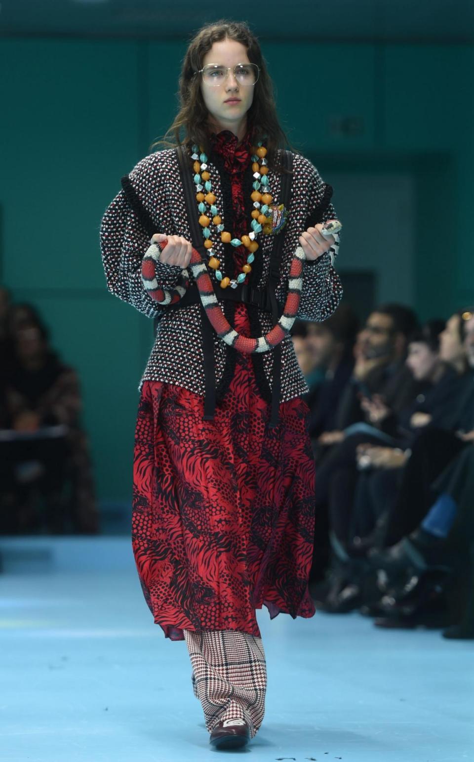 A model carries a fake snake down the catwalk (AFP/Getty Images)