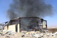 Smoke rises from a military supply post after it was hit by an air strike in Yemen's northwestern city of Saada April 1, 2015. REUTERS/Naiyf Rahma