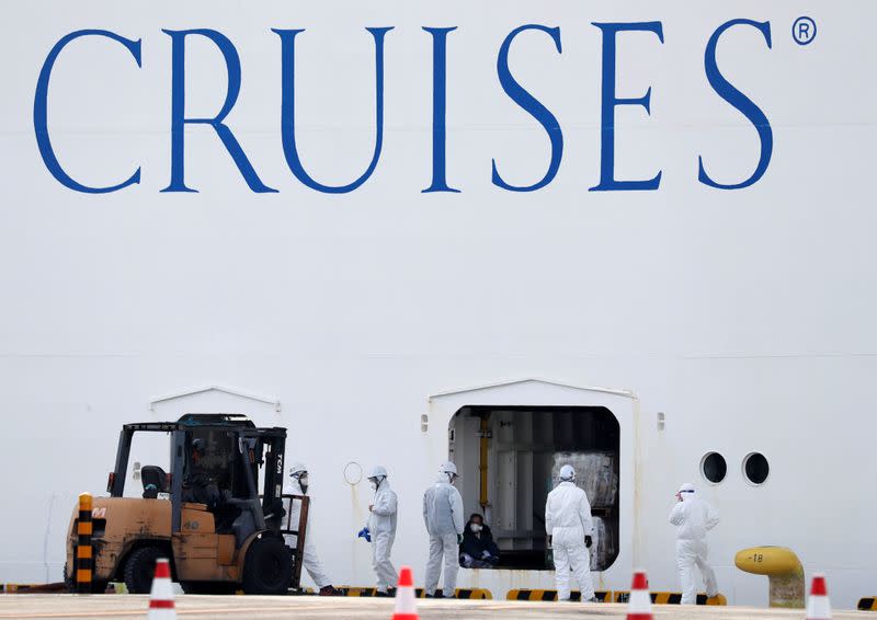 Workers in protective gear load supplies into the cruise ship Diamond Princess at Daikoku Pier Cruise Terminal in Yokohama, south of Tokyo