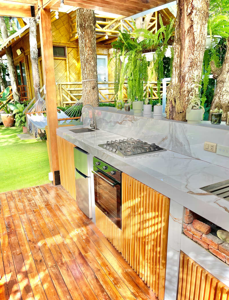 Outdoor wood, bamboo, and marble kitchen.