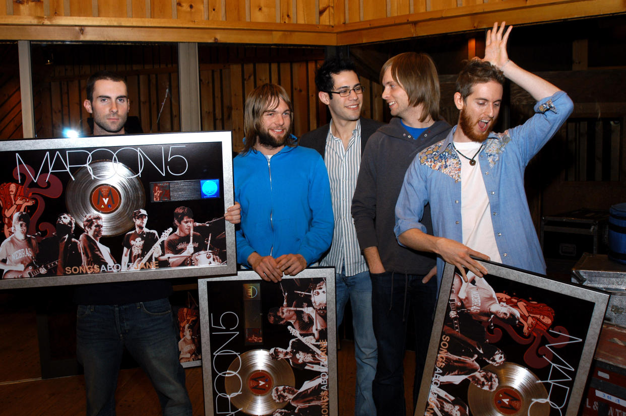 Maroon 5 's Adam Levine, Mickey Madden, Ryan Dusick, James Valentine, and Jesse Carmichael pose with platinum plaques for their debut album, 'Songs About Jane.' (Photo: Stephen Lovekin/FilmMagic)