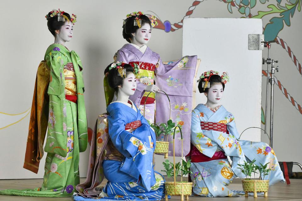 Maiko, or apprentice geiko, pose for photos ahead of the Gion Odori dance performance in Kyoto on Aug. 31, 2023.