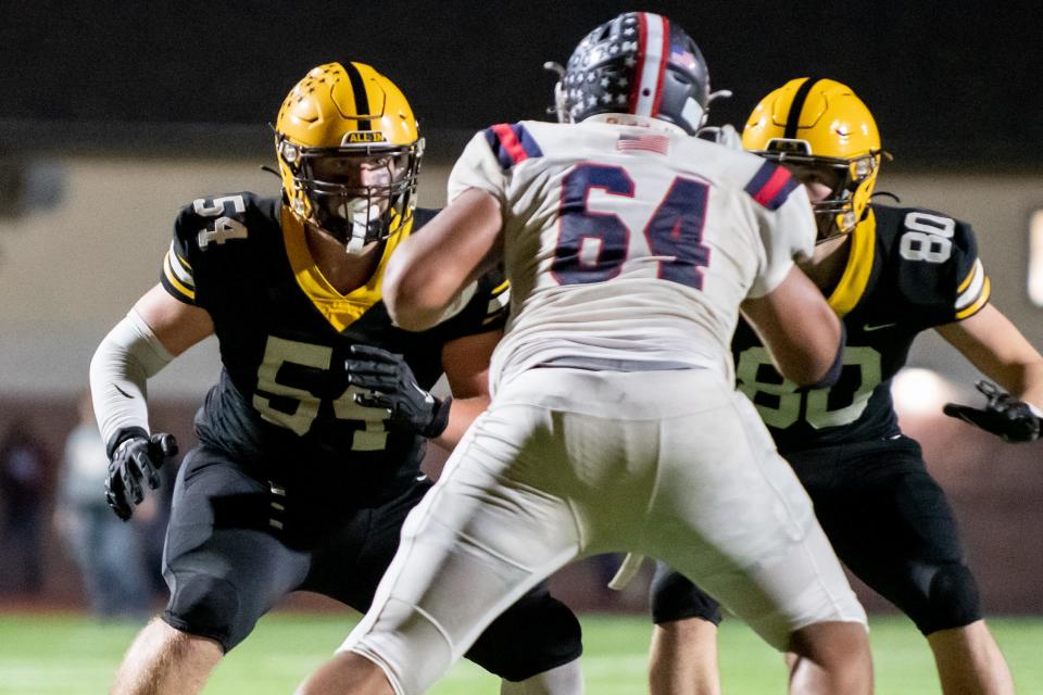 Central Bucks East standout two-way forward Mike Carroll (#64) faces blocks from CB West's Hayden Mulligan (left) and Shane Dillon during a game last season.