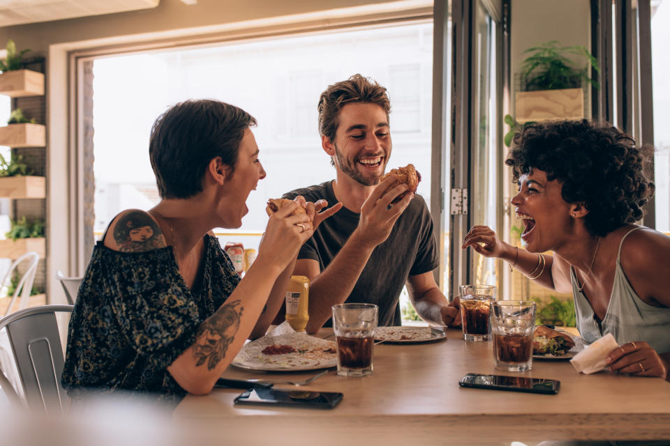 Friends eating a meal together. (Getty Images)