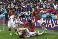 England's Harry Kane, bottom, is celebrated by teammates after scoring his side's 2nd goal the Euro 2020 soccer championship round of 16 match between England and Germany, at Wembley stadium in London, Tuesday, June 29, 2021. England won 2-0. (Andy Rain, Pool via AP)