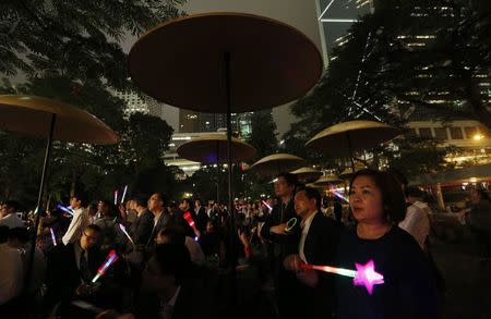 People wave luminous sticks as they take part in an anti-Occupy Central rally at Hong Kong's financial Central district November 4, 2014. REUTERS/Bobby Yip