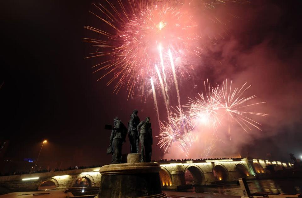 Residents watch as fireworks explode over the Stone Bridge during New Year celebrations in Skopje January 1, 2013.