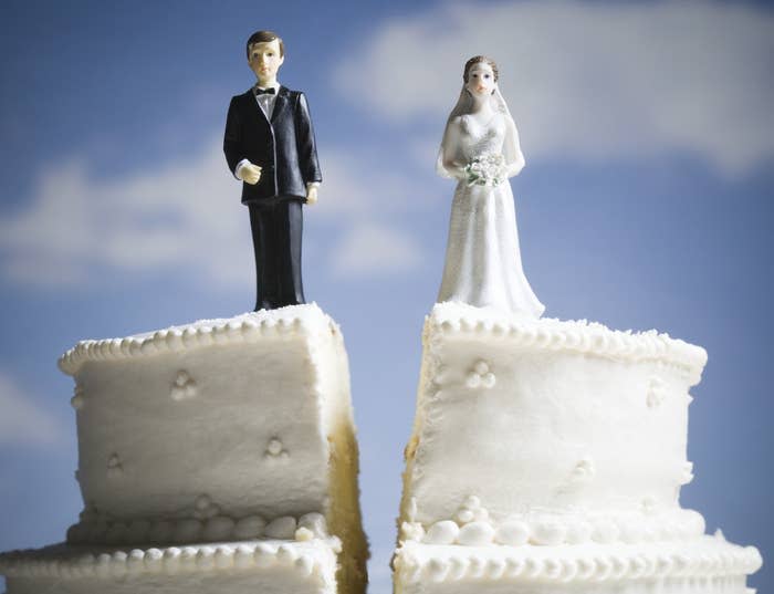 wedding cake with bride and groom on top split down the middle