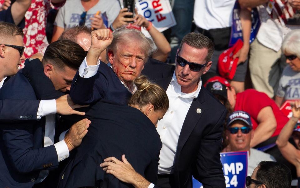 A bloodied Donald Trump in the immediate aftermath of the attempt on his life in Bulter, Pennsylvania on July 13