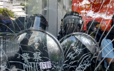 Riot police is seen inside the Legislative Council building where protesters try to break into, during the anniversary of Hong Kong's handover to China in Hong Kong