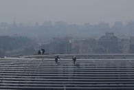 Labourers work on the top of Galaxy Soho building, in Beijing, China April 14, 2017. REUTERS/Jason Lee