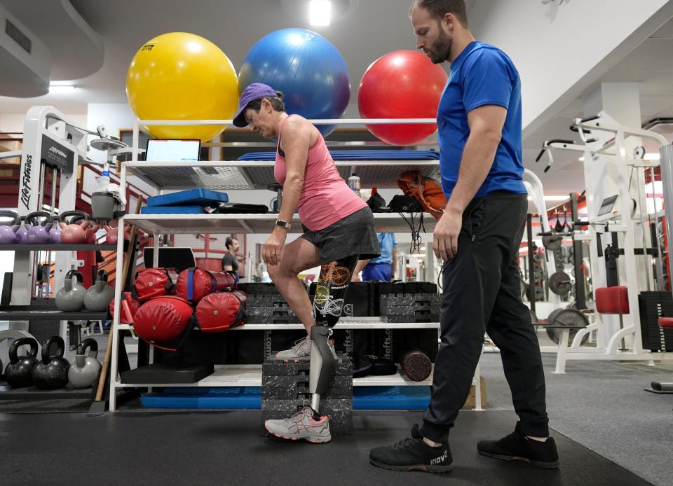 Clintonville resident Eva Simons lost her  left leg in a brutal pit bull attack a year ago, but she has reclaimed her active life and is back to bike riding. Here, she works with Todd Zody, a personal trainer at Precision Wellness, on exercises to build up her muscle strength.