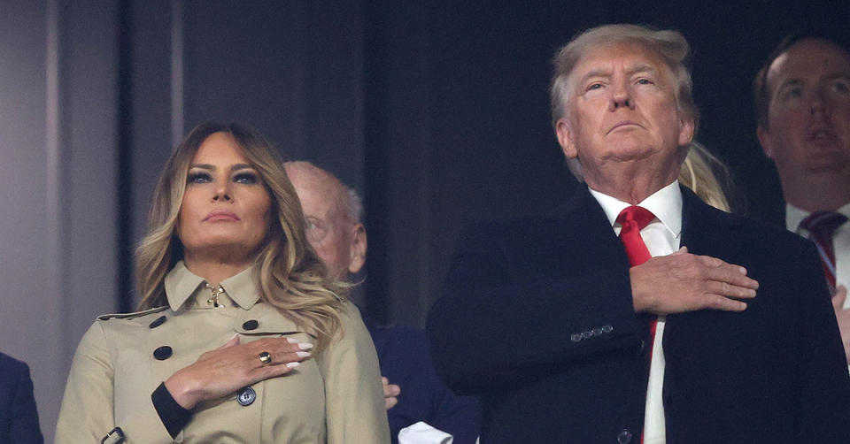 Donald and Melania Trump standing for the National Anthem