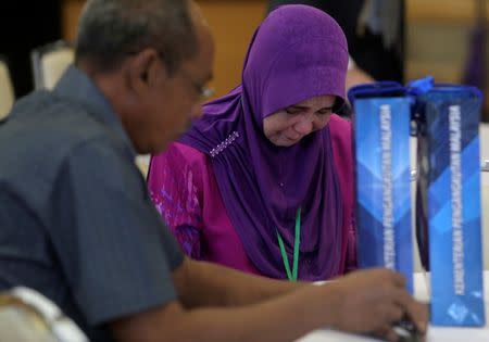 Family members wait for an MH370 closed door meeting in Putrajaya, Malaysia, July 30, 2018. REUTERS/Sadiq Asyraf