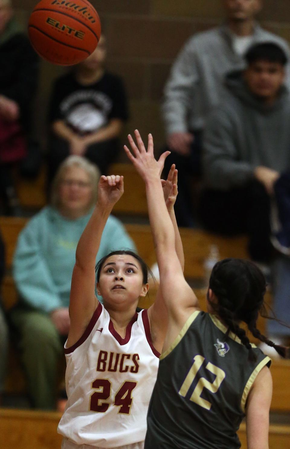 Kingston’s Isabelle Chiquiti (24) takes a shot over North Kitsap’s Jasmine Sunnenberg (12) on Tuesday, Jan. 2, 2024. Kingston won the game 41-40.