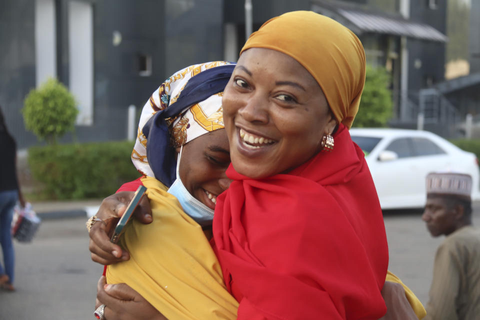 A woman welcomes her daughter who was evacuated from Sudan upon her arrival at the Nnamdi Azikiwe International Airport in Abuja, Nigeria, Friday, May 5, 2023. Many Africans escaping the conflict in Sudan that erupted with little warning last month faced a long wait - three weeks for some - to get out and severe challenges on the way as their governments stuggled to mobilize resources. (AP Photo/Gbemiga Olamikan)