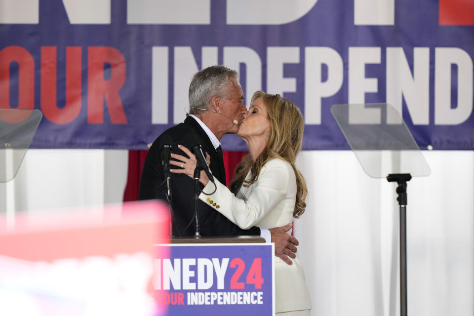 Presidential candidate Robert F. Kennedy, Jr., left, and wife, Cheryl Hines kiss after a campaign event at Independence Mall, Monday, Oct. 9, 2023, in Philadelphia. (AP Photo/Matt Rourke)