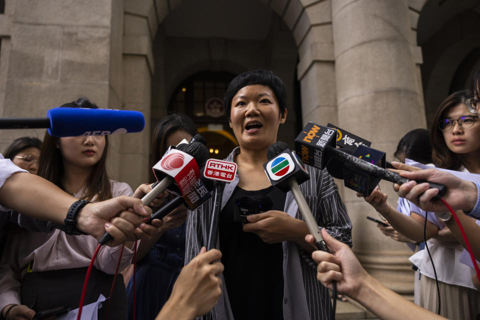 Journalist Bao Choy, center, speaks to members of the press after being cleared by the city's top court in Hong Kong, Monday, June 5, 2023. The award-winning Hong Kong journalist won an appeal quashing her conviction related to work on her investigative documentary Monday in a rare court ruling upholding media freedom in the territory. (AP Photo/Louise Delmotte)