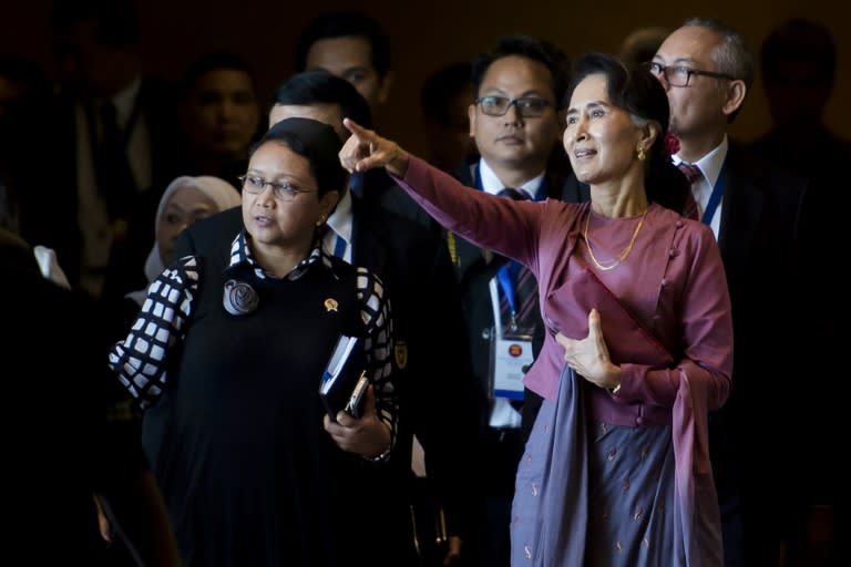 Myanmar's de facto civilian leader Aung San Suu Kyi (right) attends the Association of Southeast Asian Nations foreign ministers' meeting in Yangon on December 19, 2016