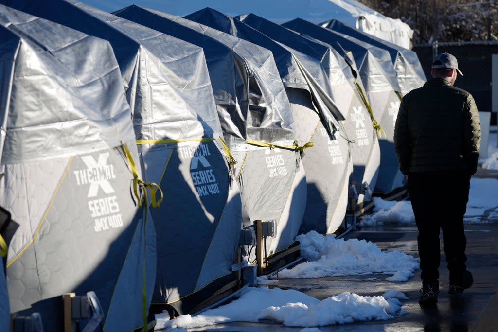 Tents stand in a long row at the east safe outdoor space in the parking lot of the city of Denver Human Service building in Denver (AP)