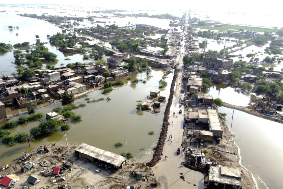 FILE - Homes are surrounded by floodwaters in Sohbat Pur city of Jaffarabad, a district of Pakistan's southwestern Baluchistan province, Aug. 29, 2022. The U.N. weather agency is predicting the phenomenon known as La Nina is poised to last through the end of this year, a mysterious “triple dip” — the first this century — caused by three straight years of its effect on climate patterns like drought and flooding worldwide. (AP Photo/Zahid Hussain, File)