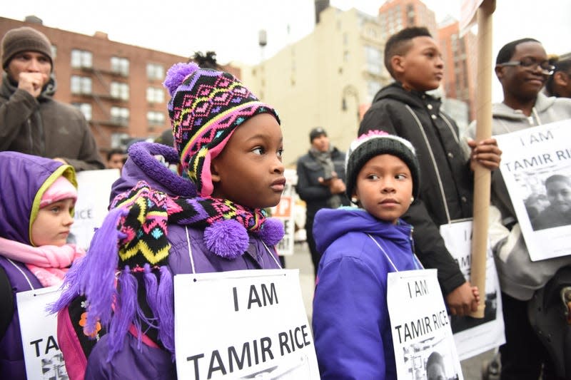 MANHATTAN, NEW YORK CITY, NEW YORK, UNITED STATES - 2015/11/22: Kids with Tamir Rice signs. Stop Mass Incarcerations Network sponsored a children’s march demanding accountability on the one year anniversary of Tamir Rice’s death at the hands of the Cleveland police. 