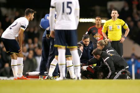 Football - Tottenham Hotspur v Swansea City - Barclays Premier League - White Hart Lane - 4/3/15 Swansea's Bafetimbi Gomis receives medical attention after sustaining an injury Action Images via Reuters / John Sibley Livepic EDITORIAL USE ONLY. No use with unauthorized audio, video, data, fixture lists, club/league logos or "live" services. Online in-match use limited to 45 images, no video emulation. No use in betting, games or single club/league/player publications. Please contact your account representative for further details.