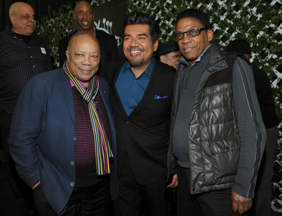 George Lopez, center, master of ceremonies for this year's Playboy Jazz Festival, poses with musicians Quincy Jones, left, and Herbie Hancock following a news conference at the Playboy Mansion on Thursday, Feb. 28, 2013 in Los Angeles. The 35th Anniversary Playboy Jazz Festival will be held at the Hollywood Bowl on June 15 and 16. (Photo by Chris Pizzello/Invision/AP)