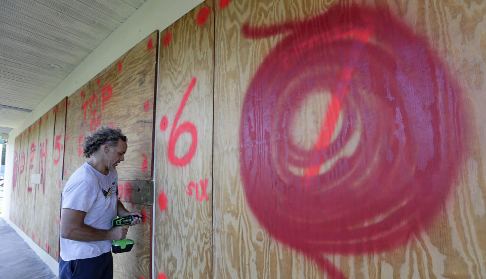 <p>Erik Budman drills a nail into the plywood as he prepares for Hurricane Irma, at a local business, Tuesday, Sept. 5, 2017, in Key Largo, Fla. (Photo: Alan Diaz/AP) </p>