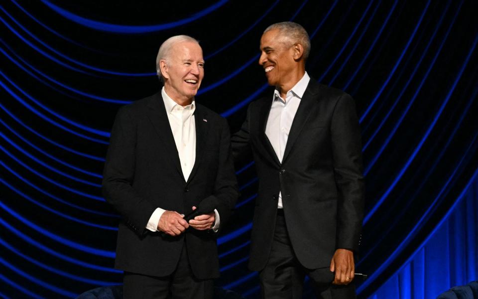 US president Joe Biden stands with former US president Barack Obama in Los Angeles on June 15