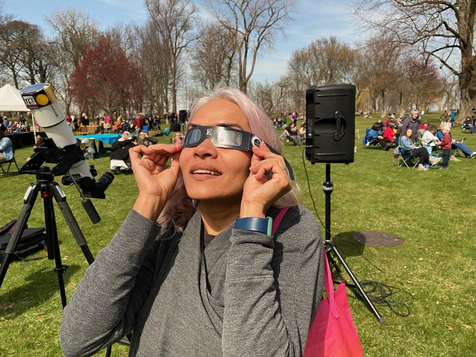 Kabita Gurung, 47, of Warren, watches the solar eclipse Monday, April 8, 2024, at Ford House in Grosse Pointe Shores.