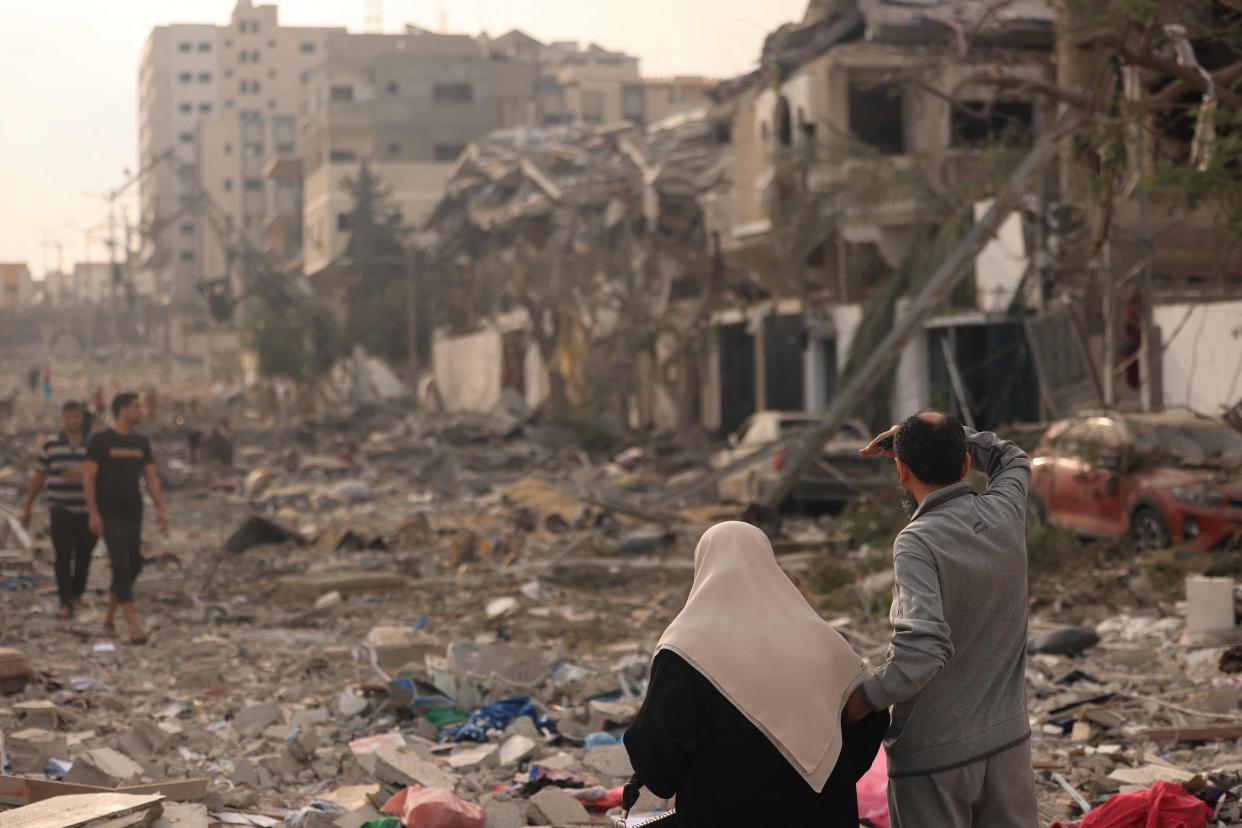 Palestinians inspect the massive destruction from Israeli airstrikes in Gaza City’s al-Rimal district on Tuesday (AFP via Getty Images)